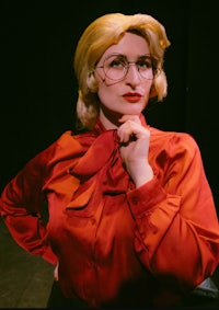 a woman wearing glasses and a red shirt